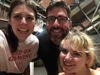 Hallie, Chris, and Catherine smiling at the camera and celebrating one year of podcasting